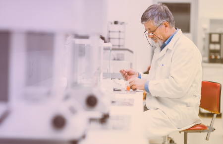scientist sitting in front of a table inside a lab
