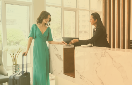 woman in green dress at front desk