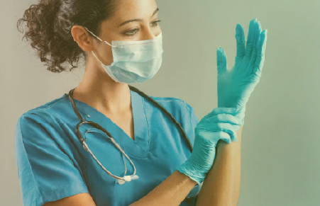 nurse putting on an exam glove