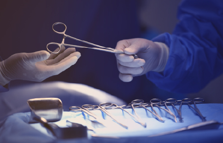 doctor handing surgical instrument to another doctor